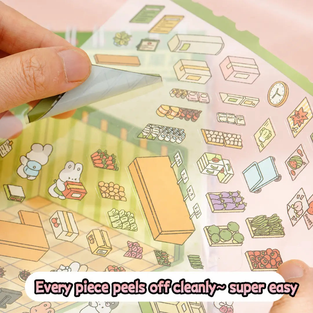 Close-up of a pre-cut PET sticker piece being peeled from a scene sticker sheet