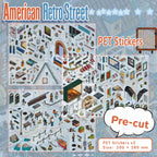 Three pre-cut PET sticker sheets with buildings, people, windows, bikes, signs, and street details for a retro city scene
