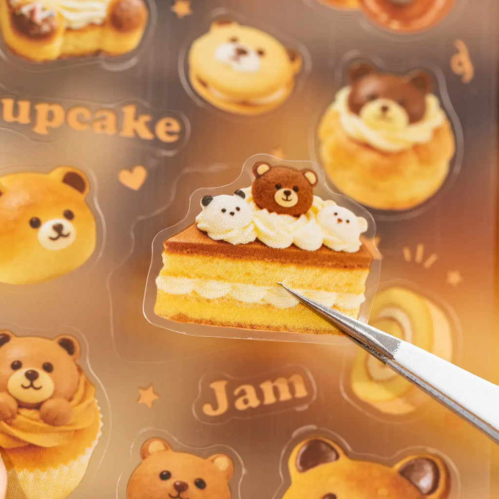 Close-up of a bear cake sticker being lifted from the Baking Story Journaling Sticker Set