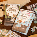 Bear Diary journaling sticker set with Manor Chronicle and Holiday Time booklet-style sticker packs displayed on a wooden desk