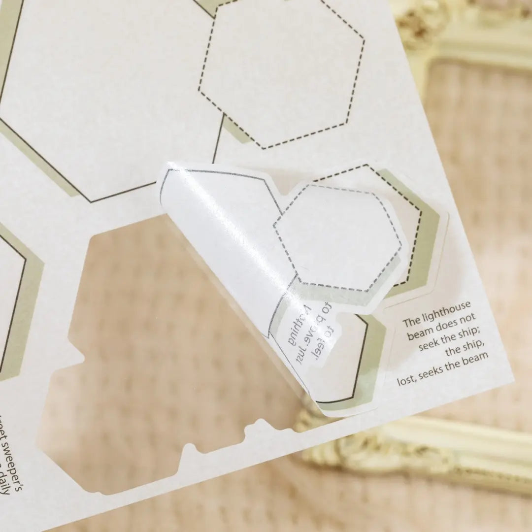 Close-up of a writable border sticker being peeled from a journaling sticker sheet