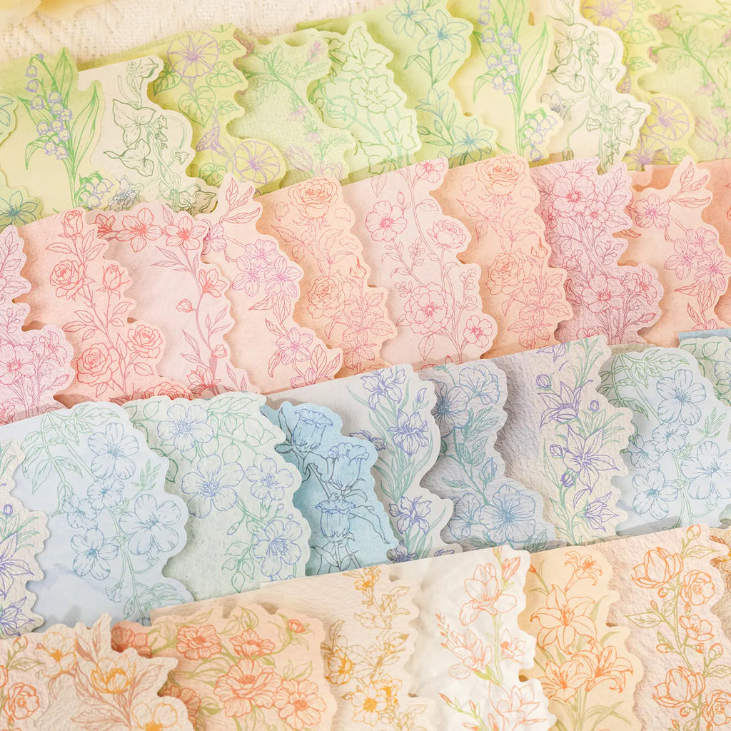 Close-up of pastel floral journaling stickers with scalloped botanical edges