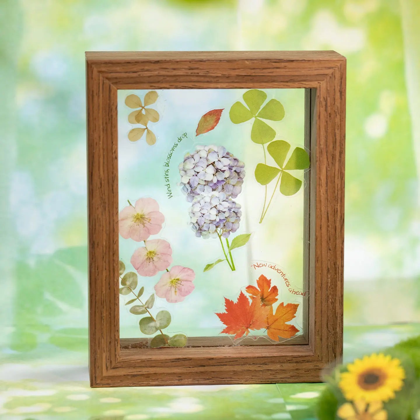 Botanical stickers used in a small frame with hydrangea, clover, and maple leaf designs