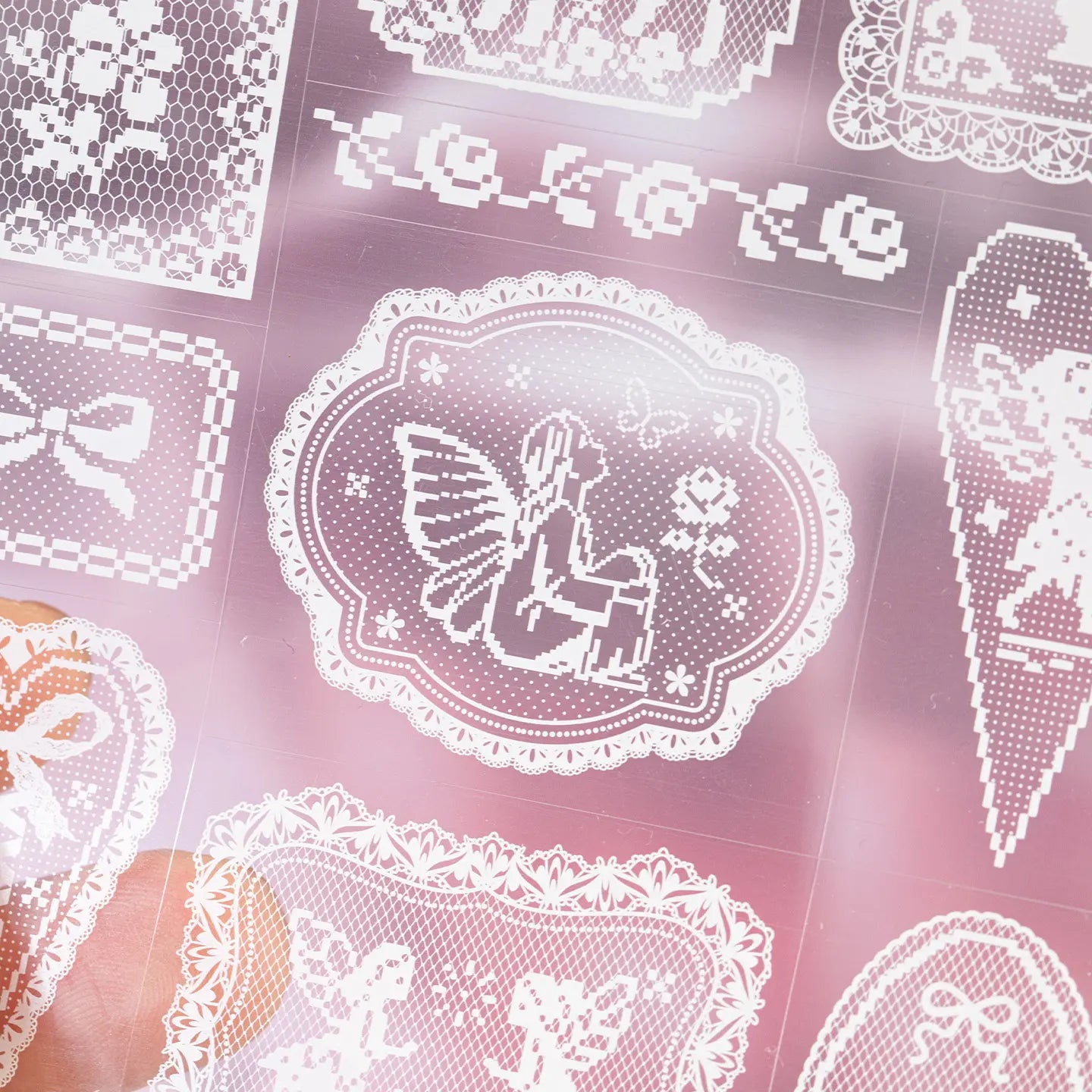 Close-up of pink lace-style frame and bow stickers from the Breathing Space Journaling Sticker Set