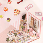 Close-up of miniature cake displays, café chairs, plants, and shop details in the Cake Story scene sticker kit