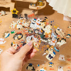 Multiple transparent cat sticker sheets from the Cat Diary Journaling Sticker Set held in hand