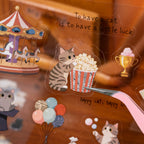 Close-up of a transparent PET cat sticker being lifted with tweezers
