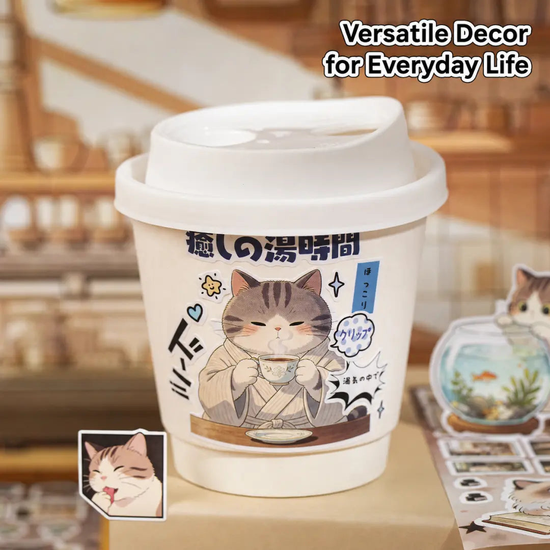 Cat Journey sticker applied to a takeaway cup with a cozy tea-drinking cat illustration