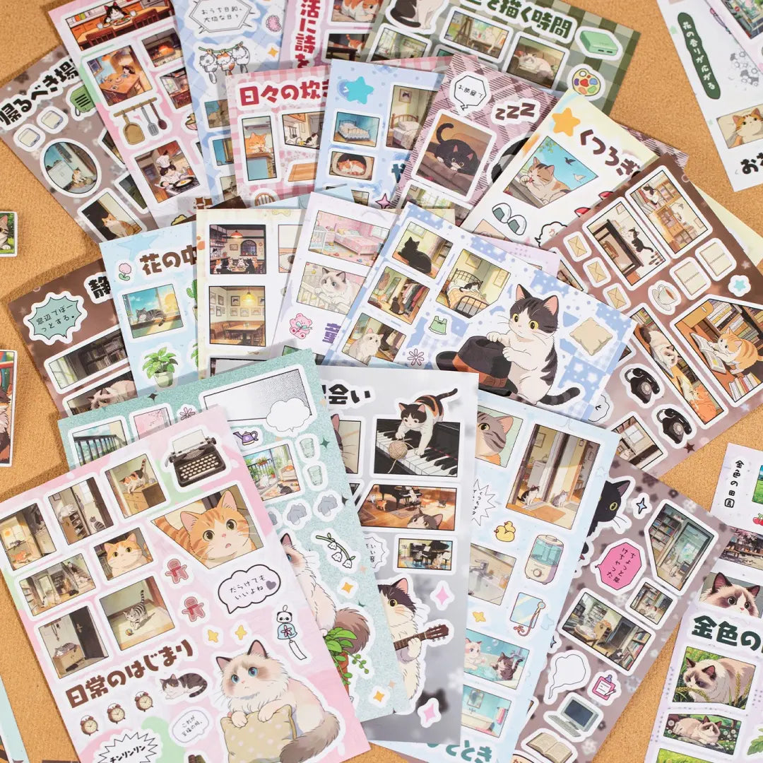 Cat Journey sticker sheets arranged in a flat lay with Japanese-style cat illustrations, room scenes, speech bubbles, plants, and photo-frame details