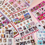 Close-up flat lay of Cat’s Day sticker sheets with photo-style cats, captions, frames, and decorative collage elements