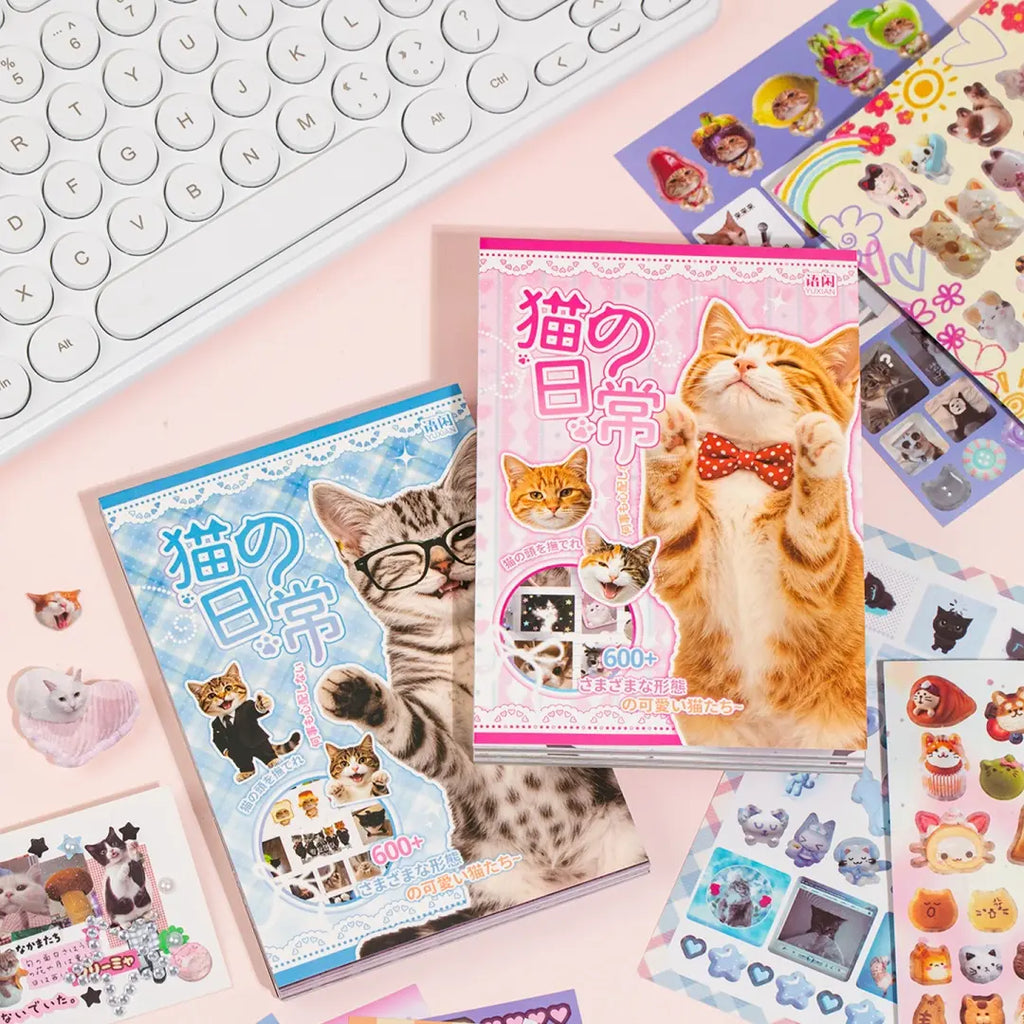 Cat’s Day journaling sticker set with pink and blue cat sticker books displayed on a desk with loose cat stickers