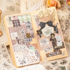 Paper cup decorated with layered butterfly, music, grid, and celestial journaling stickers