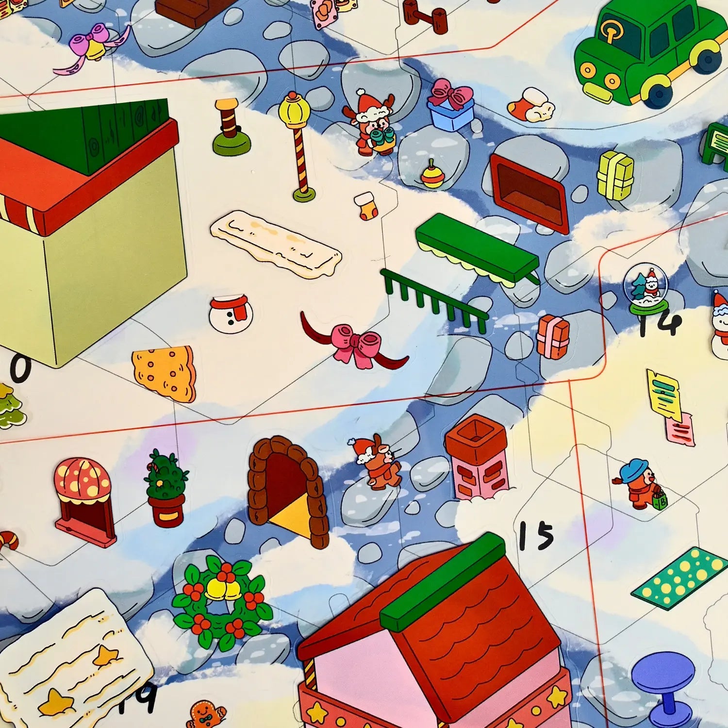 Close-up of Christmas buildings, decorations, and characters placed on the numbered snowy scene card