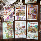 Finished postcard-style scenes from Chronicle of Time and Star Travel Wonders arranged on a wooden desk