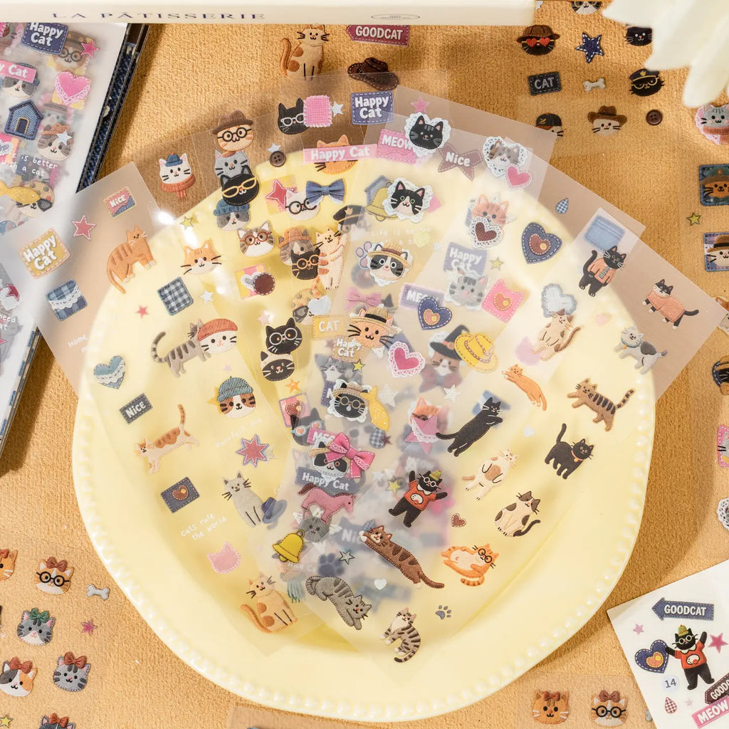 Clear and matte cat sticker sheets displayed with patchwork-style cat illustrations