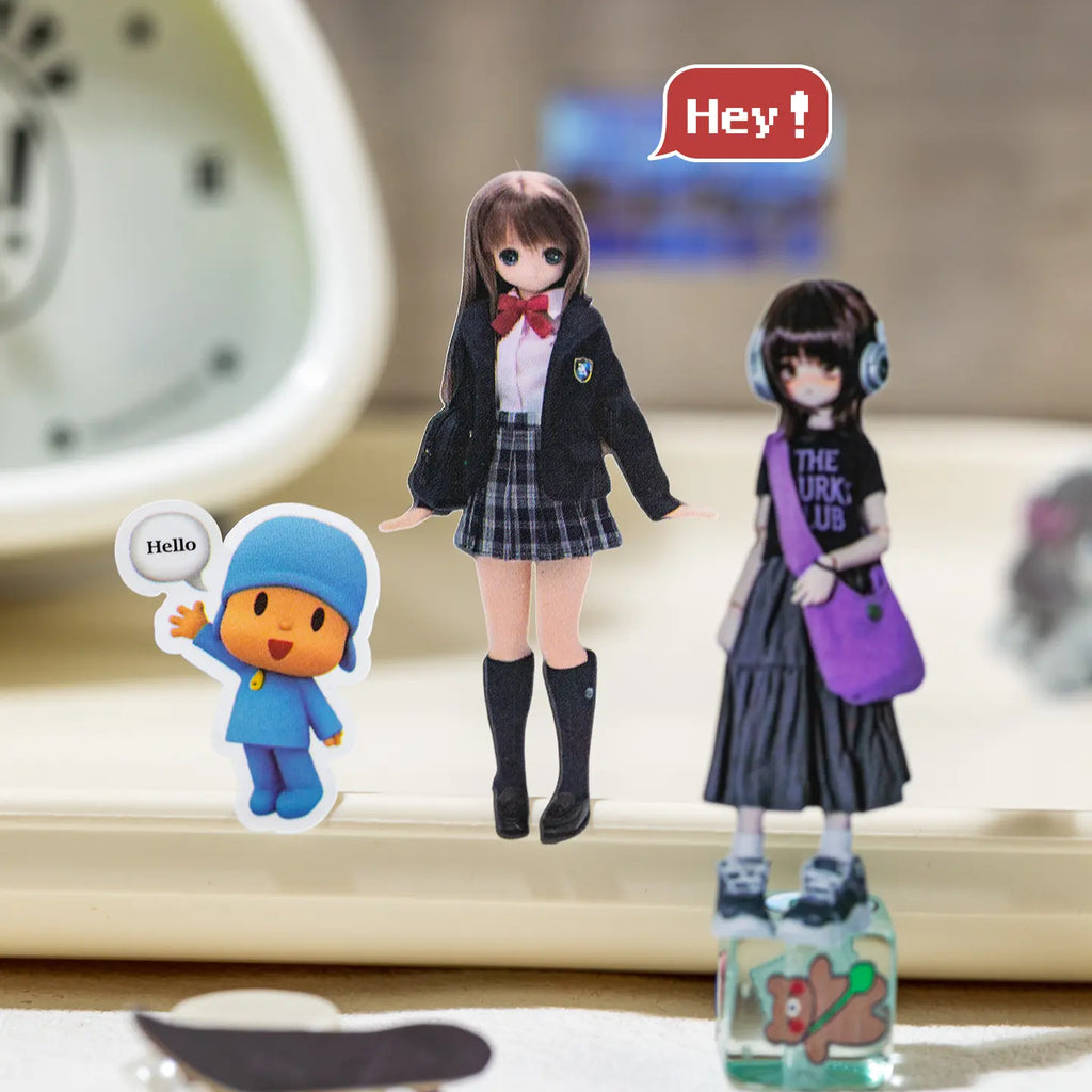 Close-up of character-style stickers from the Colorful Daily Life Journaling Sticker Book arranged on a desk