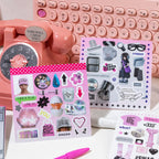 Colorful Daily Life Journaling Sticker Book displayed with sticker sheets and pink stationery on a desk