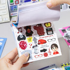 Side view of the Colorful Daily Life Journaling Sticker Book showing multiple coated paper sticker pages