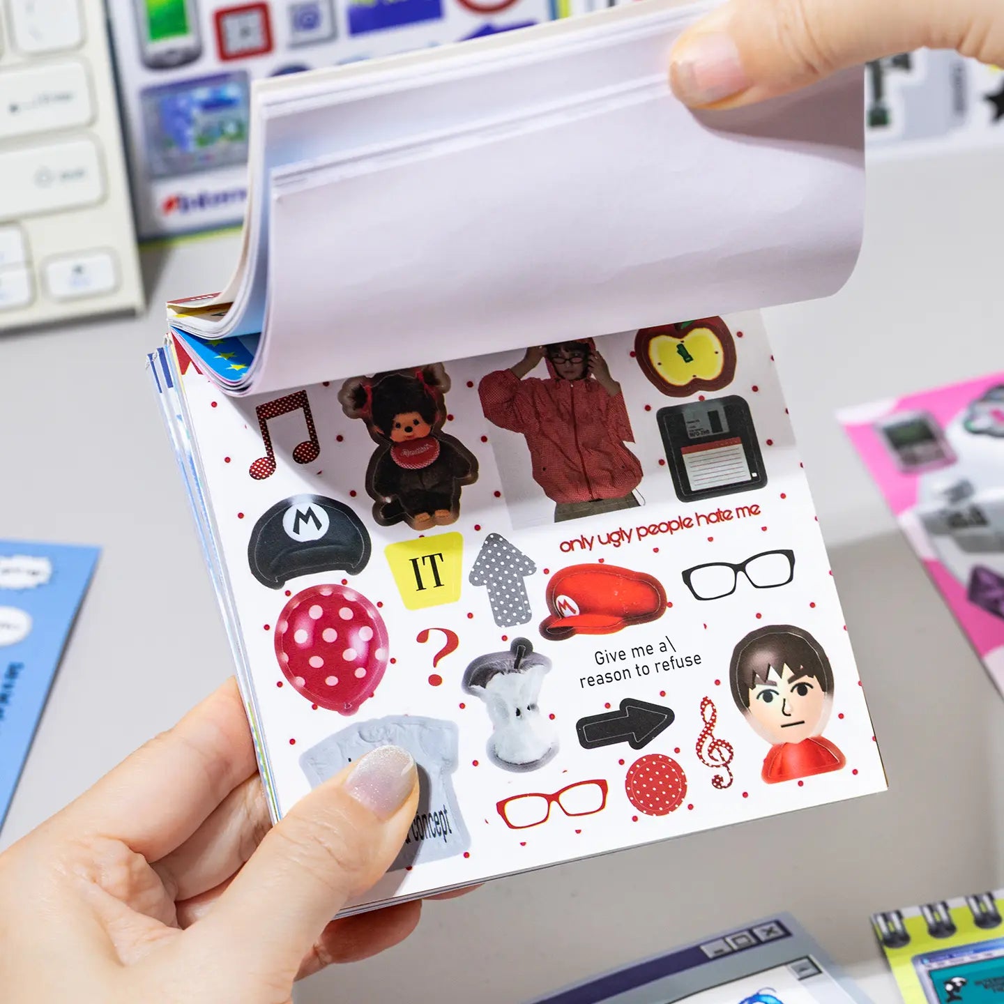 Side view of the Colorful Daily Life Journaling Sticker Book showing multiple coated paper sticker pages