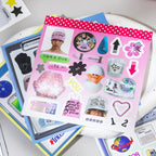 Close-up of a pink sticker sheet from the Colorful Daily Life Journaling Sticker Book with icons, labels, and collage elements