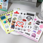 Sticker sheet from the Colorful Electronic Journaling Sticker Book with cute icons, hearts, dice, and speech bubble details