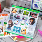 Green digital-themed sticker sheet from the Colorful Electronic Journaling Sticker Book with phone, message, and character-style stickers