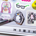 Close-up of a penguin sticker being lifted from the Colorful Electronic Journaling Sticker Book