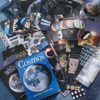 Cosmic Mystery Junk Journal Kit celestial ephemera flat lay with moon papers, stickers, cards, and dark blue collage pieces