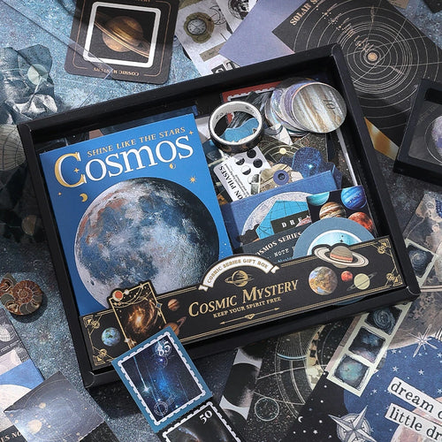 Packaged Cosmic Mystery Junk Journal Kit with moon, planet, and astronomy-themed papers, stickers, and ephemera