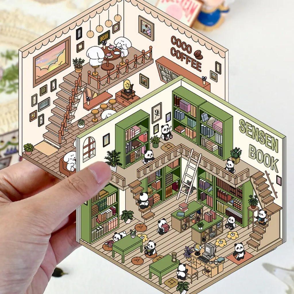 Hand holding the panda bookstore and Coco Coffee 3D scene sticker designs as finished miniature room cards