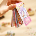 Side view of the Creekside Ferry scene sticker book showing multiple small sticker and base card pages inside
