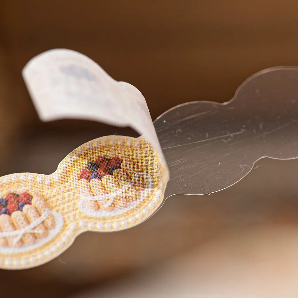 Close-up of a crochet-look journaling sticker showing washi paper texture and peeling detail