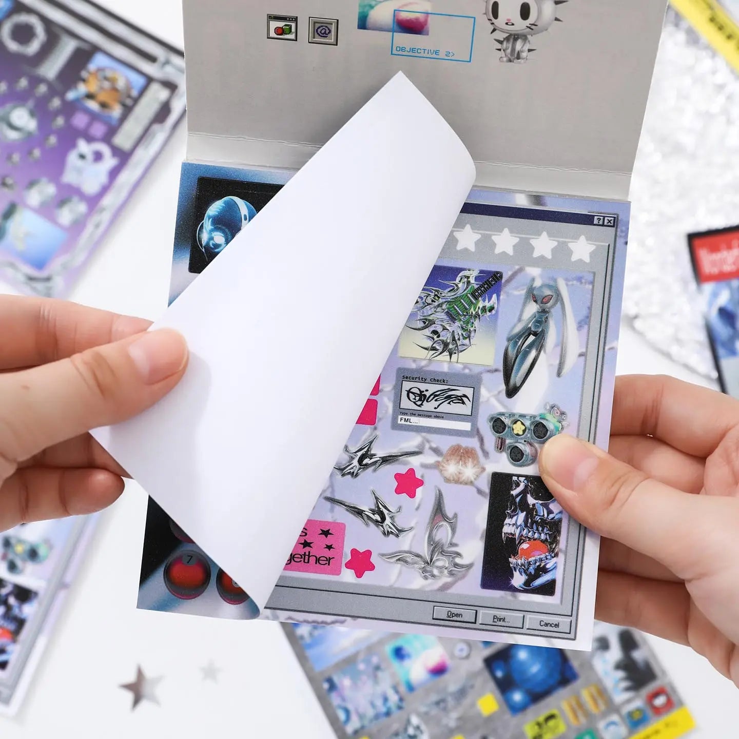 Hands flipping through a Cyber Illusion sticker book with glossy cyber-style sticker sheets