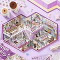 Dreamy Craft Shop 3D Scene Sticker Kit finished display with fabric shelves, sewing tables, dresses, and a purple miniature craft store layout