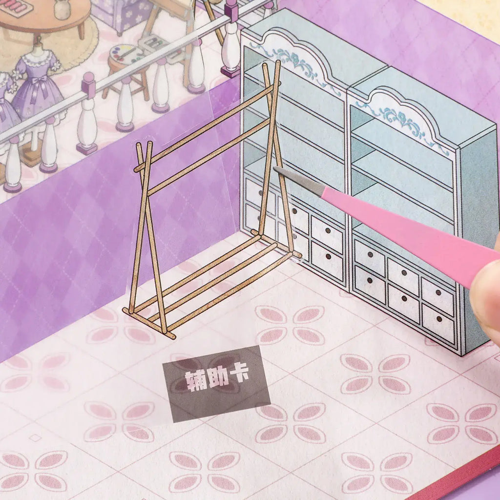 Close-up of a craft rack sticker being placed onto the Dreamy Craft Shop scene card with tweezers