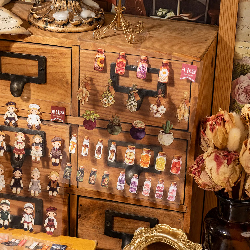 Completed dried flower and doll shop scenes created with miniature transparent stickers