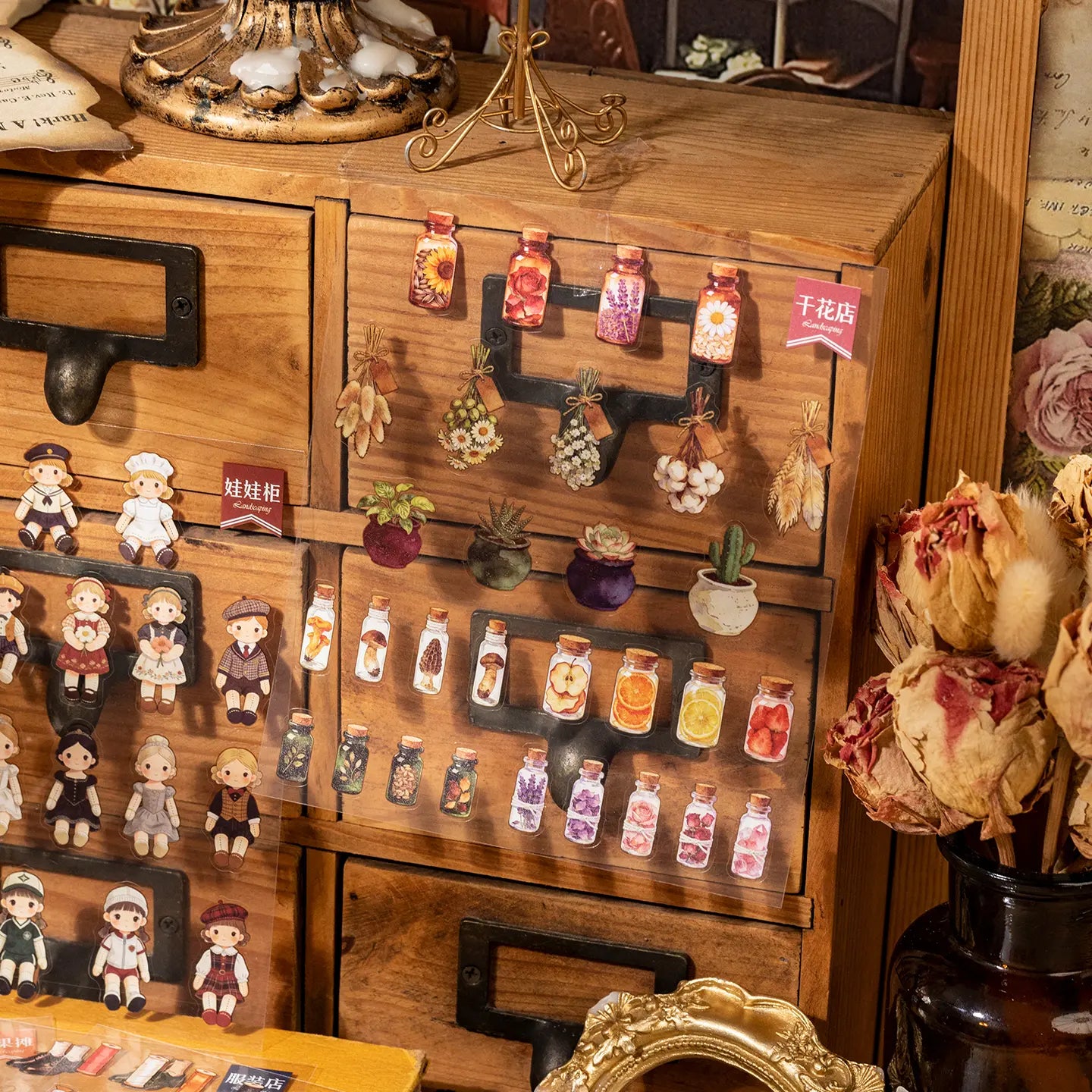Completed dried flower and doll shop scenes created with miniature transparent stickers