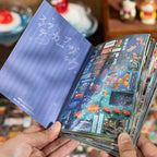 Open Echoes of Memory Journaling Sticker Book showing goldfish and retro memory collage sticker pages