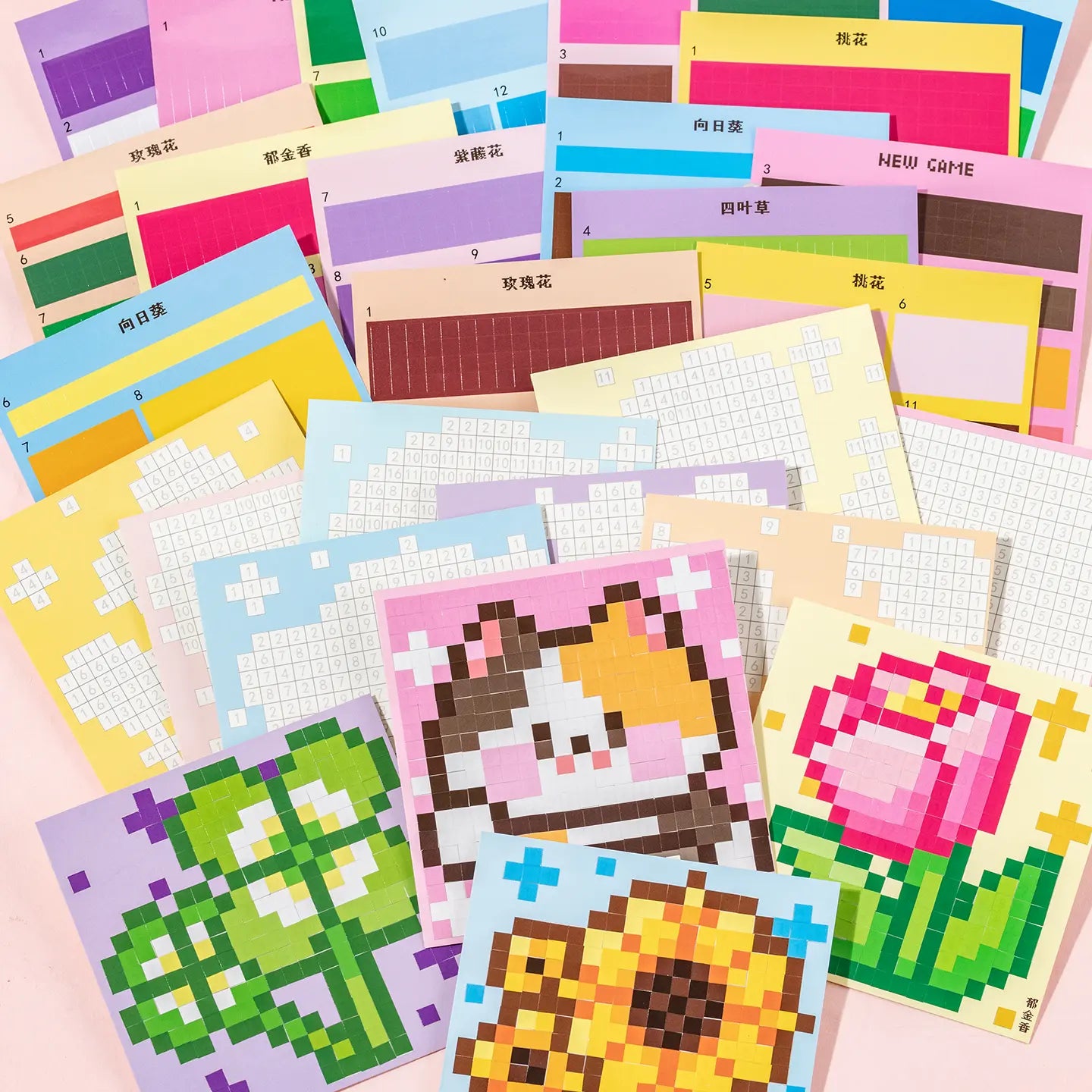 Flower Garden pixel mosaic scene cards and sticker sheets spread out on a pink background