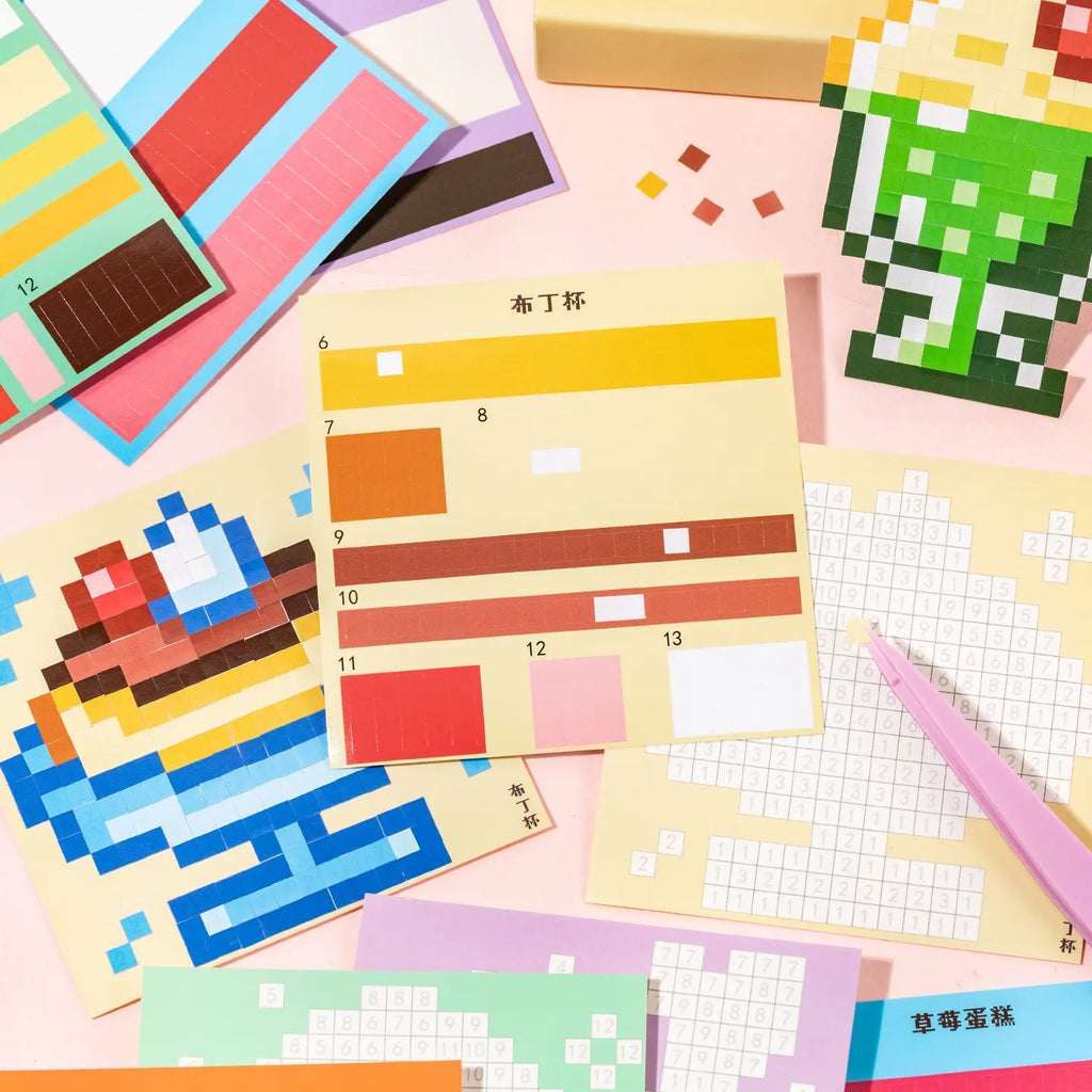 Gourmet Collection pixel mosaic design pages and sticker sheets spread out on a pink background
