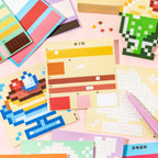Gourmet Collection pixel mosaic design pages and sticker sheets spread out on a pink background