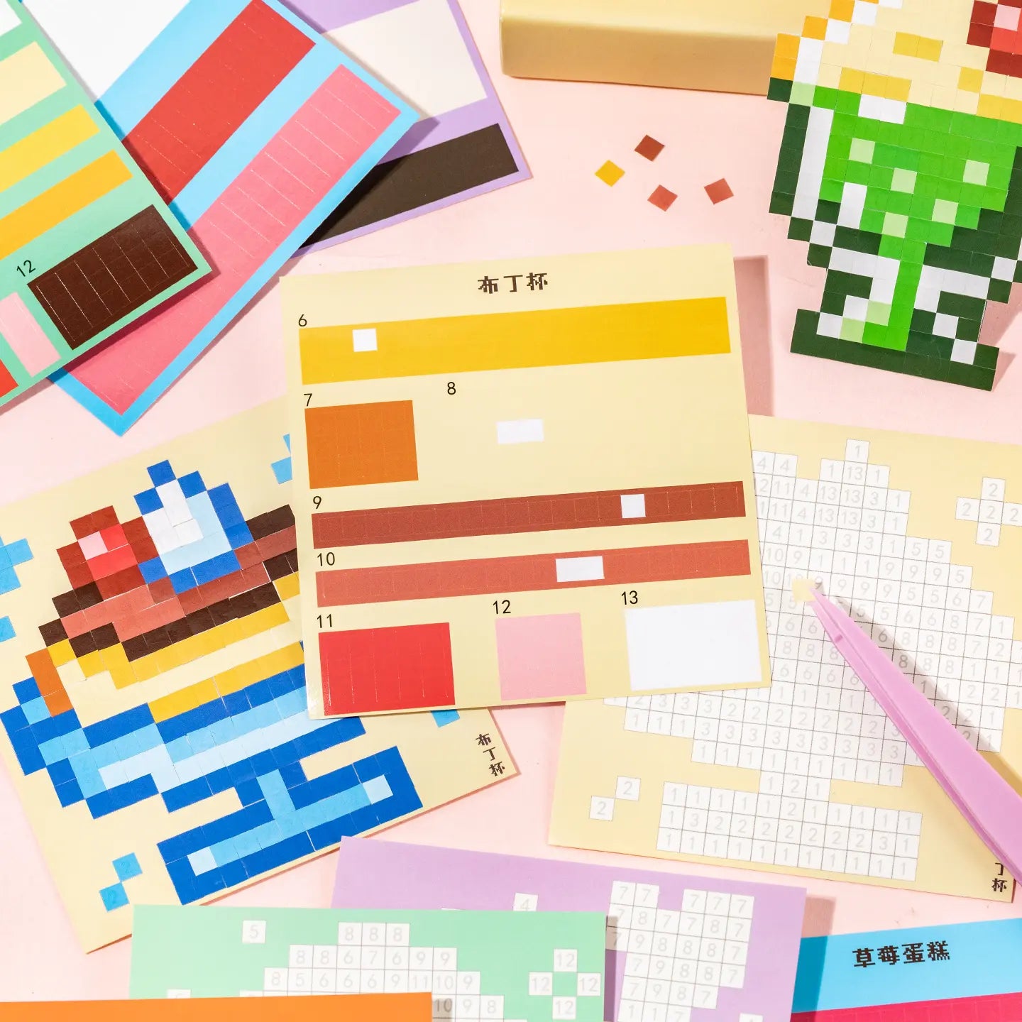 Gourmet Collection pixel mosaic design pages and sticker sheets spread out on a pink background