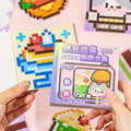 Gourmet Collection Pixel Mosaic Sticker Book held in hand with purple cover design