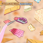 Close-up of glossy-laminated pre-cut stickers from the Little Stories in the Carton kit showing a small keyboard sticker