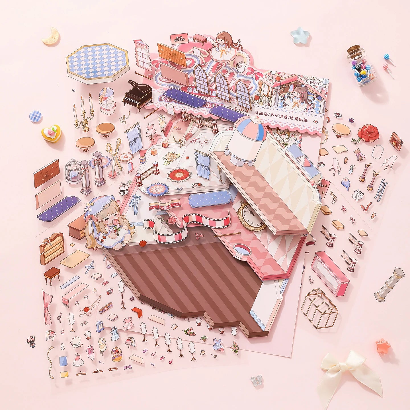 Flat lay of Lolita Dollhouse scene sticker kit pieces, sticker sheets, and foldable background