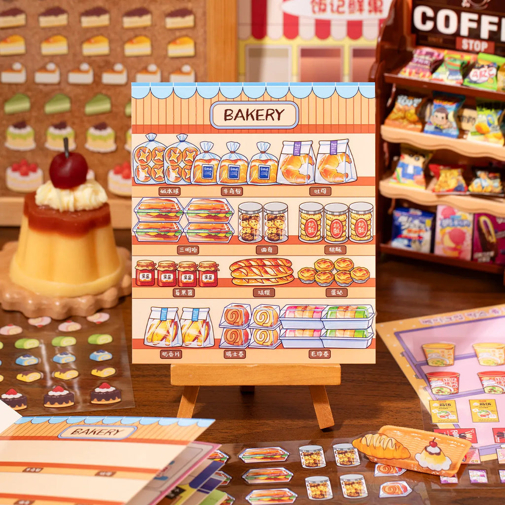 Finished bakery scene card with bread, pastries, jars, and shelf display stickers