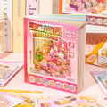 Mini House Builder 3D Scene Sticker Book standing upright with pink cover and room scene artwork