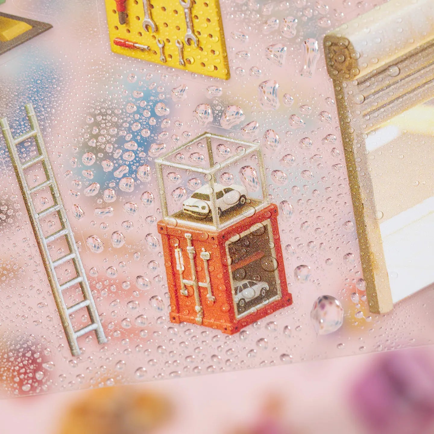 Close-up of a glossy PET sticker sheet with a repair shop display case and small water droplets on the surface