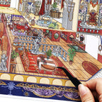 Close-up of placing furniture stickers on the Oracle Realm miniature fantasy room scene card