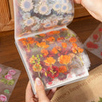 Open floral sticker pack showing orange flower sticker sheets